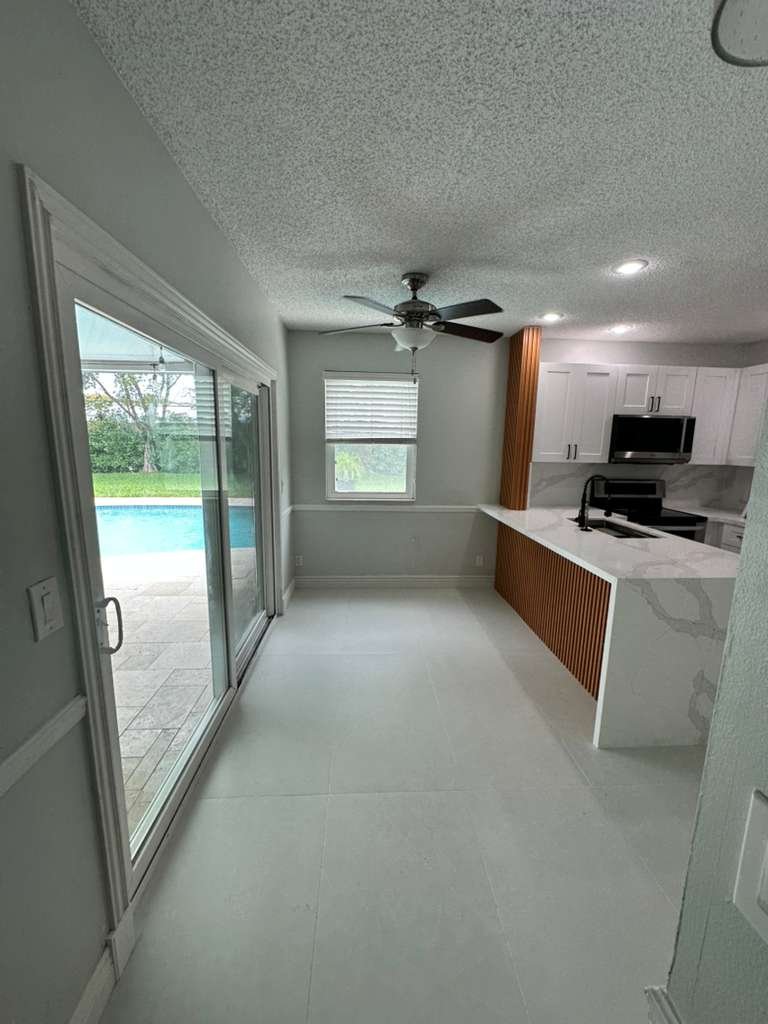 kitchen remodel with white cabinets quartz countertops and pool view – Temecula CA